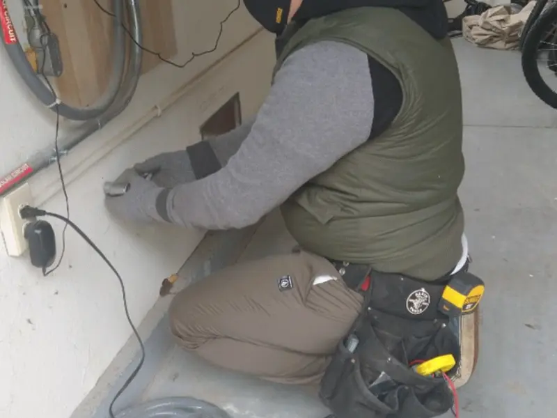 Electrician performing outlet wiring in a New Berlin garage