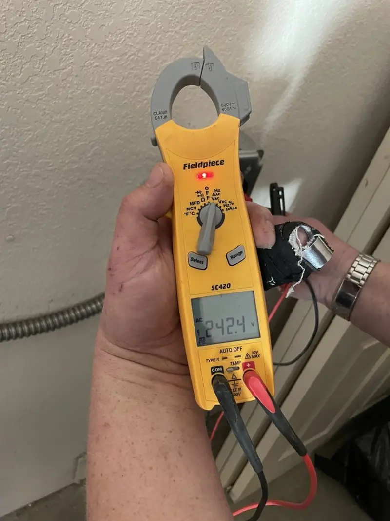 Voltage testing with clamp meter during Recessed Lighting Installation in New Berlin
